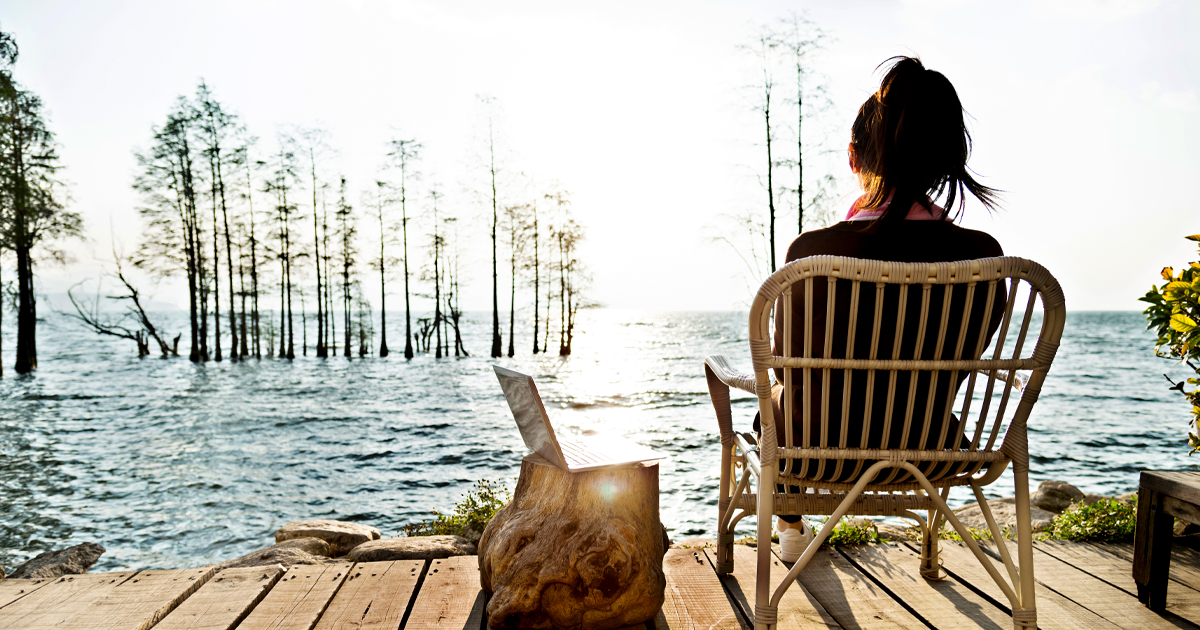 woman sitting by lake