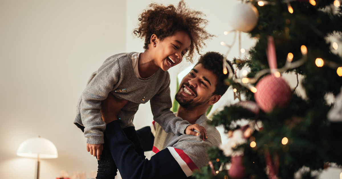 father and daughter by Christmas tree