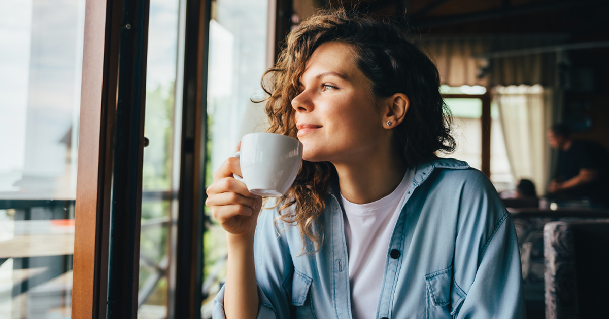 woman smiling with coffee mug
