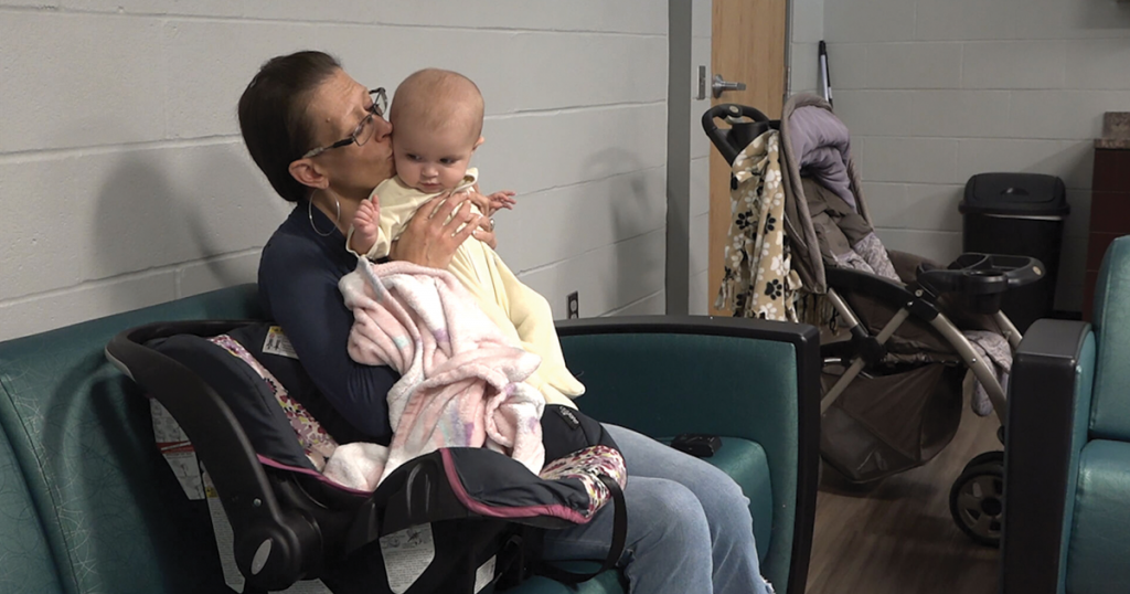 Bailey Gris kisses her 6-month-old daughter Anatalia “Tally” Faye at the Army’s Booth Center in St. Joseph, MO. She has stayed at the shelter for a little over 100 days while developing a home stability plan.