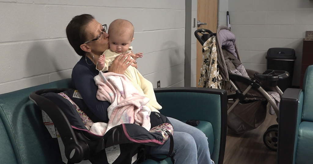 Bailey Gris kisses her 6-month-old daughter Anatalia “Tally” Faye at the Army’s Booth Center in St. Joseph, MO. She has stayed at the shelter for a little over 100 days while developing a home stability plan. 