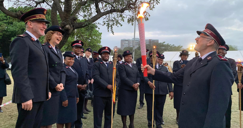 Divisional leaders and other Salvationists gather for a torch-lighting ceremony in Albert Park, Durban